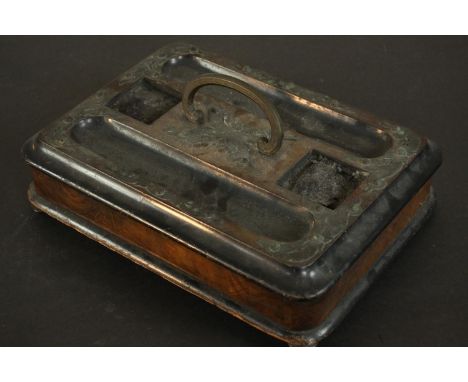 A Victorian aesthetic movement desk stand, burr walnut and ebonised wood with brass mounts, with inkwell and pen recesses ove