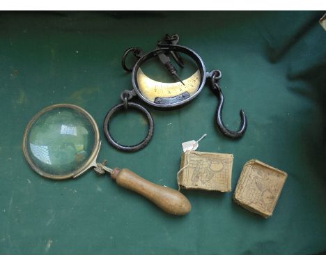 Box containing mixed hand held magnifier, 2 original boxes of nose rings and brass weighing tool