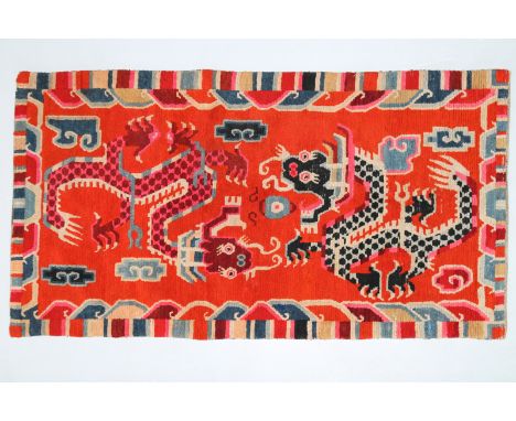  Arte Himalayana. A wooden carpet depicting two dragons over a red background  Tibet, late 19th - early 20th century . Cm 86,