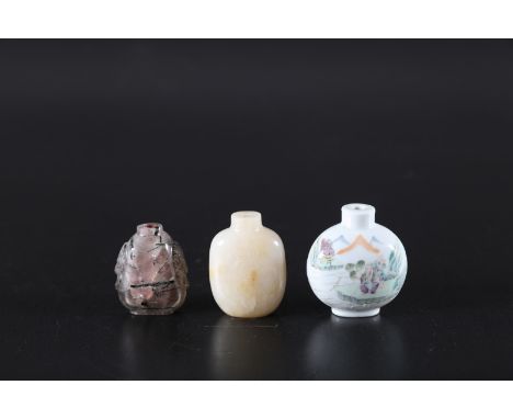 Arte Cinese . Lot comprising of three snuff bottles: a rutile crystal, a jade one and a milk porcelain snuff bottle painted w