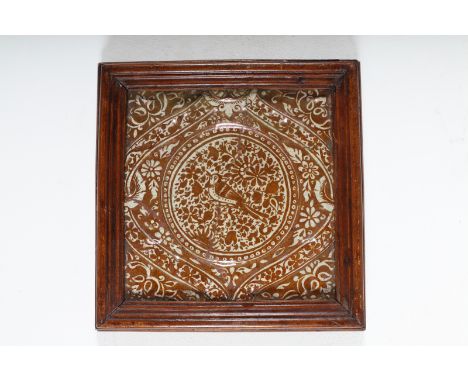  Arte Islamica. A pottery tile painted with lustre depicting a bird among flowers and sprays  Iran, Qajar dynasty, 19th centu