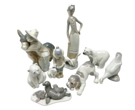 Seven Lladro figures, comprising Playful Puppy no 9135, Platero and Marcelino/Boy Hugging Donkey no 1181, Mini Seal Family no