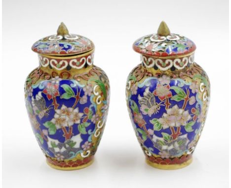 Pair Chinese cloisonne enamel lidded jars each with blossom decorated enamel on blue ground, (height 10cm approx, each).