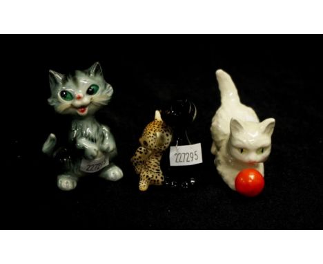 Three various Goebel kitten/cat figurines including a white cat playing with a red ball, a leopard &amp; black cat together, 