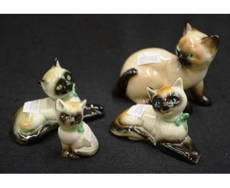 Four various Goebel Siamese cat figurines all marked to base, width