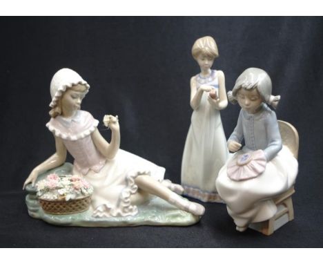 Lladro seated girl with flower basket figure (one finger broken), (height 18cm approx); together with a Lladro standing girl 