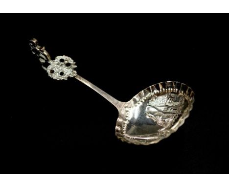 Dutch silver sauce ladle tests as silver, with traditional in relief figural decoration, approximate total weight 15 grams