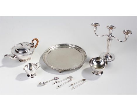 Silver plated tray, tea pot, two bowls, two sets of tongs,spoon and candleabra.