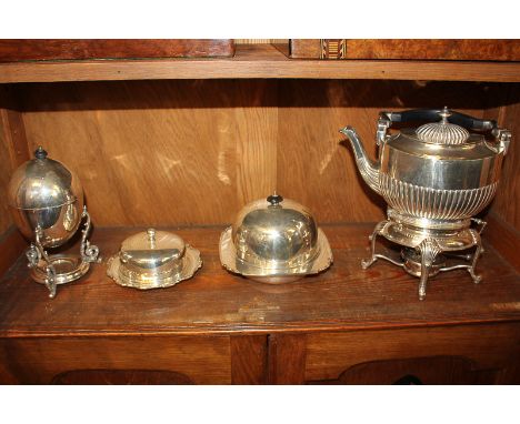 A collection of silver plated tableware, comprising an oval kettle on stand with burner, an egg coddler, a Harrods muffin dis