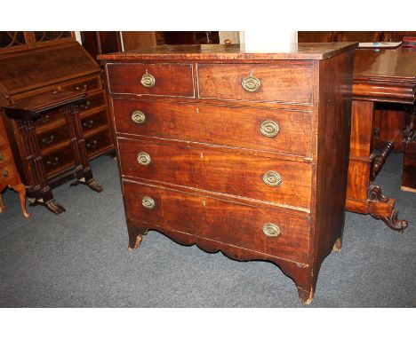 A George III mahogany chest of two short over three long drawers with brass oval drop handles, shaped base, on bracket feet, 