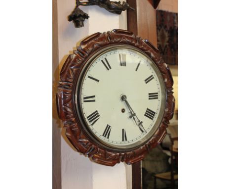 A circular wall clock with floral carved wood surround, 12 inch enamel dial with Roman numerals, 43cm