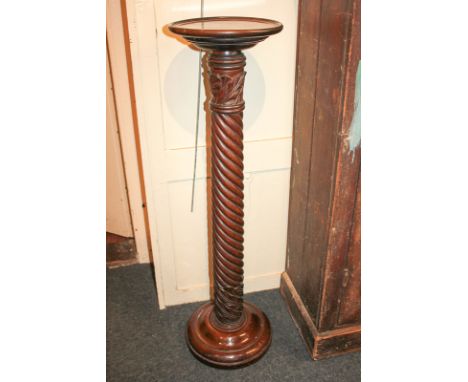A mahogany torchiere stand with acanthus carved spiral stem on circular base, 101cm