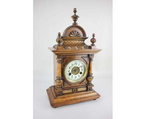 A 20th century German walnut cased mantel clock with striking movement, Arabic enamelled chapter ring, key and pendulum, 47cm