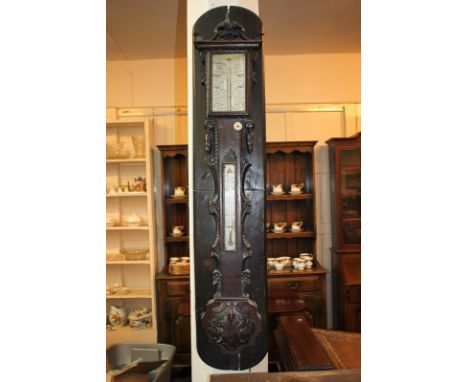 A Victorian barometer and thermometer marked T & H Doublet, in carved oak case mounted on curved back plate, 110cm long, plat