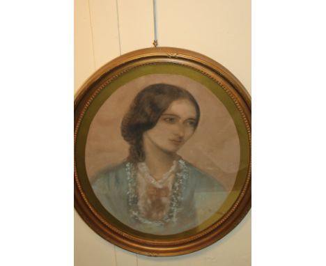 An early 20th century oval pastel portrait of a young woman in blue dress, 53cm by 42cm