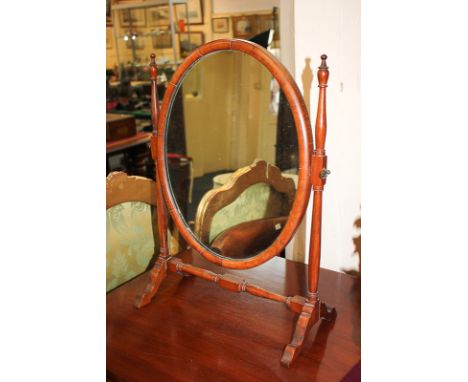 An oval dressing table mirror on adjustable stand with turned supports, mirror plate 41cm by 31cm