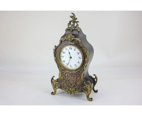 A 19th century boulle and brass inlaid mantel clock with scrolling brasswork on waisted case, the white enamel dial with Arab