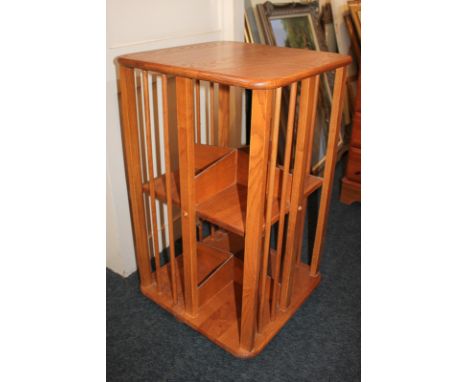 An Ercol style two-tier revolving bookcase with spindle supports, 44.5cm