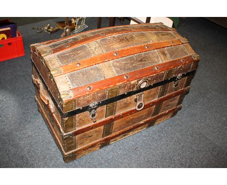 A late Victorian leather and wooden bound trunk with dome top and carry handles, bears initials CB, 82.5cm