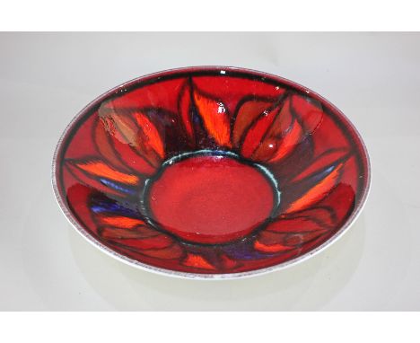 A large Poole Pottery flared bowl, abstract pattern on red ground, shape No 58, 34cm diameter