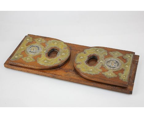 A brass mounted extending book stand with hinged end supports with Egyptian head profile, 35cm