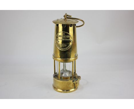 A brass miner's lamp, The Protector Lamp & Lighting Co Ltd, Eccles, Manchester, 25cm high