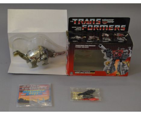 A boxed Transformers Dinobot Jungle Warrior 'Sludge'. The model has been removed from the packaging although the instruction 