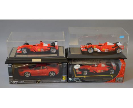 Two boxed Hot Wheels 1:18 scale diecast model Ferrari cars, a Ferrari F430 and a limited edition F1 car from the Michael Schu