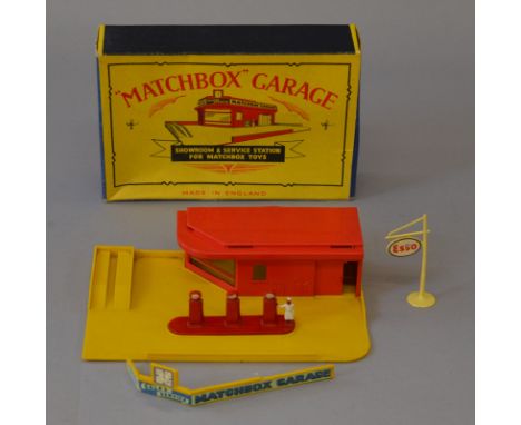 An early boxed Matchbox Lesney MG-1 Garage, in red and yellow plastic complete with an unboxed set of diecast 'Esso' pumps an