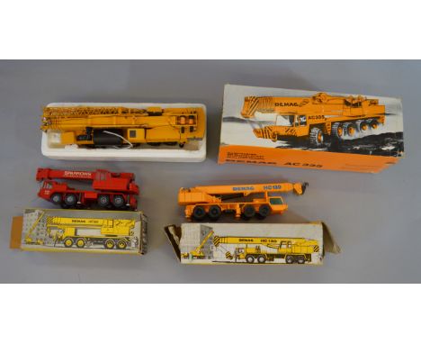 Three boxed 1:50 scale diecast model Demag Crane Trucks, a Conrad AC335 together with an HC130 and a HC120 both by NZG. Model