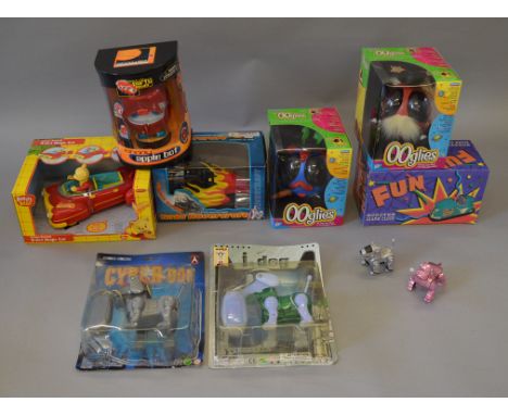 A mixed lot of toys including five boxed battery operated items including two Ooglies, a Johnny Apple Bot and a Scooter Alarm