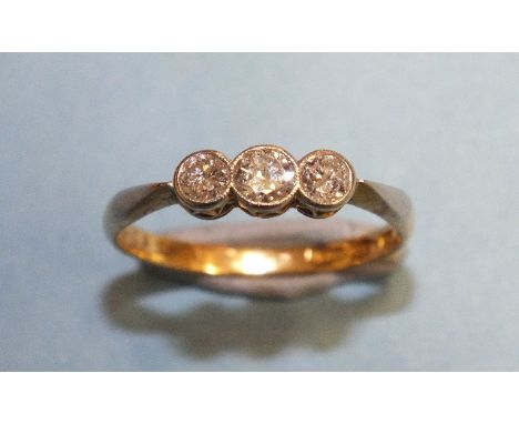 A three-stone diamond ring millegrain-set three brilliant-cut diamonds, in 18ct yellow gold and platinum mount, size P½, 2.4g