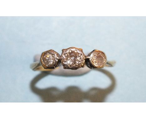 A three-stone diamond ring in 18ct gold and platinum mount, (very worn), size J, 1.7g.