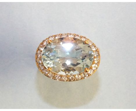 A 9ct gold dress ring set oval blue topaz and white stone cluster, size M, 5.6g.