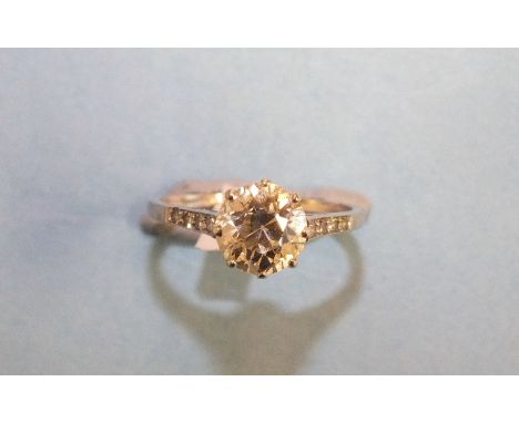 A solitaire diamond ring claw-set a brilliant-cut diamond of approximately 1.3cts, VVS, M-N, in unmarked white metal  mount, 