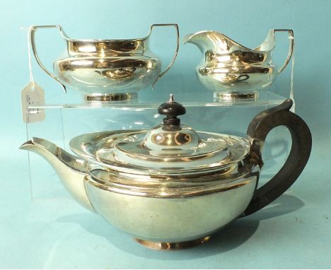 A plain cream jug and sugar basin of compressed form, London 1905 and a matched silver teapot of similar design,___33 oz..