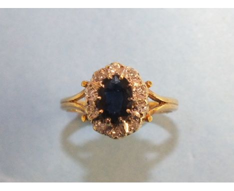 A sapphire and diamond cluster ring with 9ct gold mount, size K½, 2.5g.