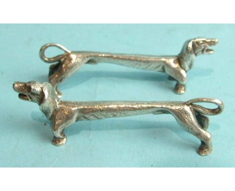 A pair of knife rests in the form of dachshunds, maker R&amp;D, Sheffield 1973, 8cm long.