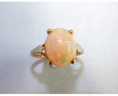 An 18ct gold ring claw-set an oval opal, (13 x 10mm), size P, 3.6g.