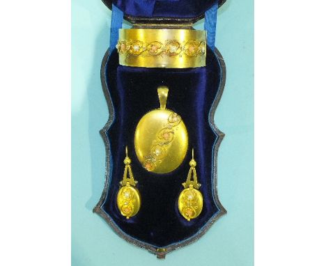 A Victorian demi-parure c1880, comprising hinged bangle, pendant and drop earrings, each matt gold piece overlaid with applie