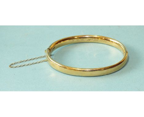 A 15ct gold hinged bangle bearing inscription, (damaged), 11.4g.