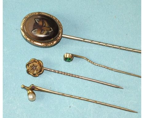 An early-20th century fox head stick pin, a small 15ct gold stick pin set ruby and pearl and two other stick pins, (4).