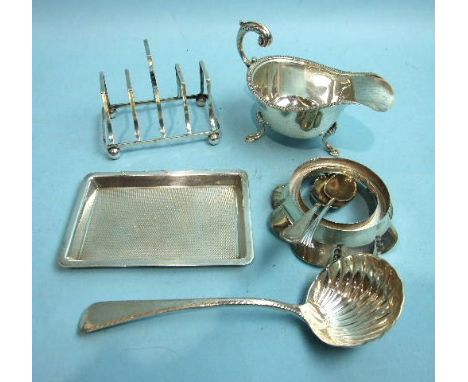 A small silver toast rack on ball feet, Chester 1904 an engine turned rectangular small tray, London, 1928 and other small si