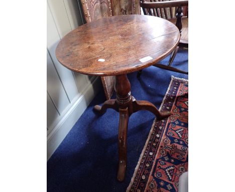 A GEORGE III OAK TRIPOD TABLE, 18th century and later elements, with circular top and baluster stem, 67cm high, 49cm diameter