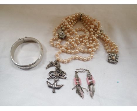 A COLLECTION OF COSTUME JEWELLERY, including an engraved silver bangle and a clear paste pendant in the form of a bird