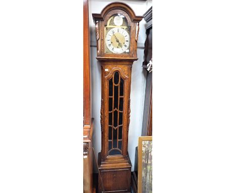 A 1920S OAK CASED GRANDMOTHER CLOCK with three train movement and brass and silvered dial, 168cm high 