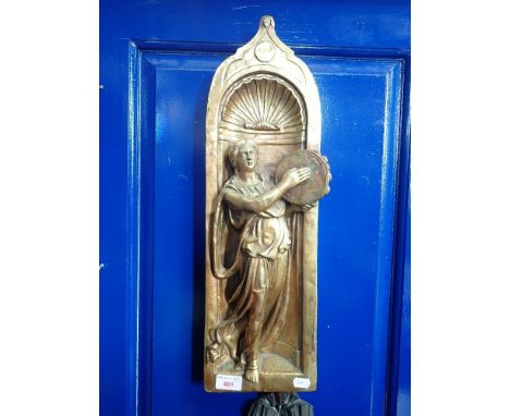 A CAST BRASS PLAQUE OF A WOMAN PLAYING A TAMBOURINE in relief, 54cm high