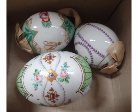 THREE RUSSIAN PORCELAIN EASTER EGGS decorated with enamel and gilt