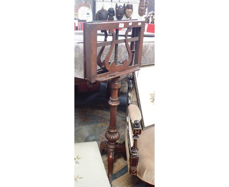 A VICTORIAN MAHOGANY MUSIC STAND on tripod base