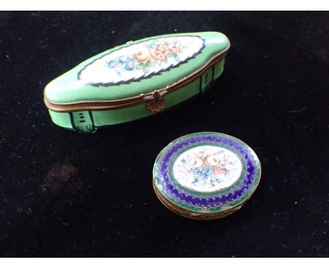 A PORCELAIN PILLBOX decorated with flowers and an enamel pillbox with a spray of flowers and mirrored interior